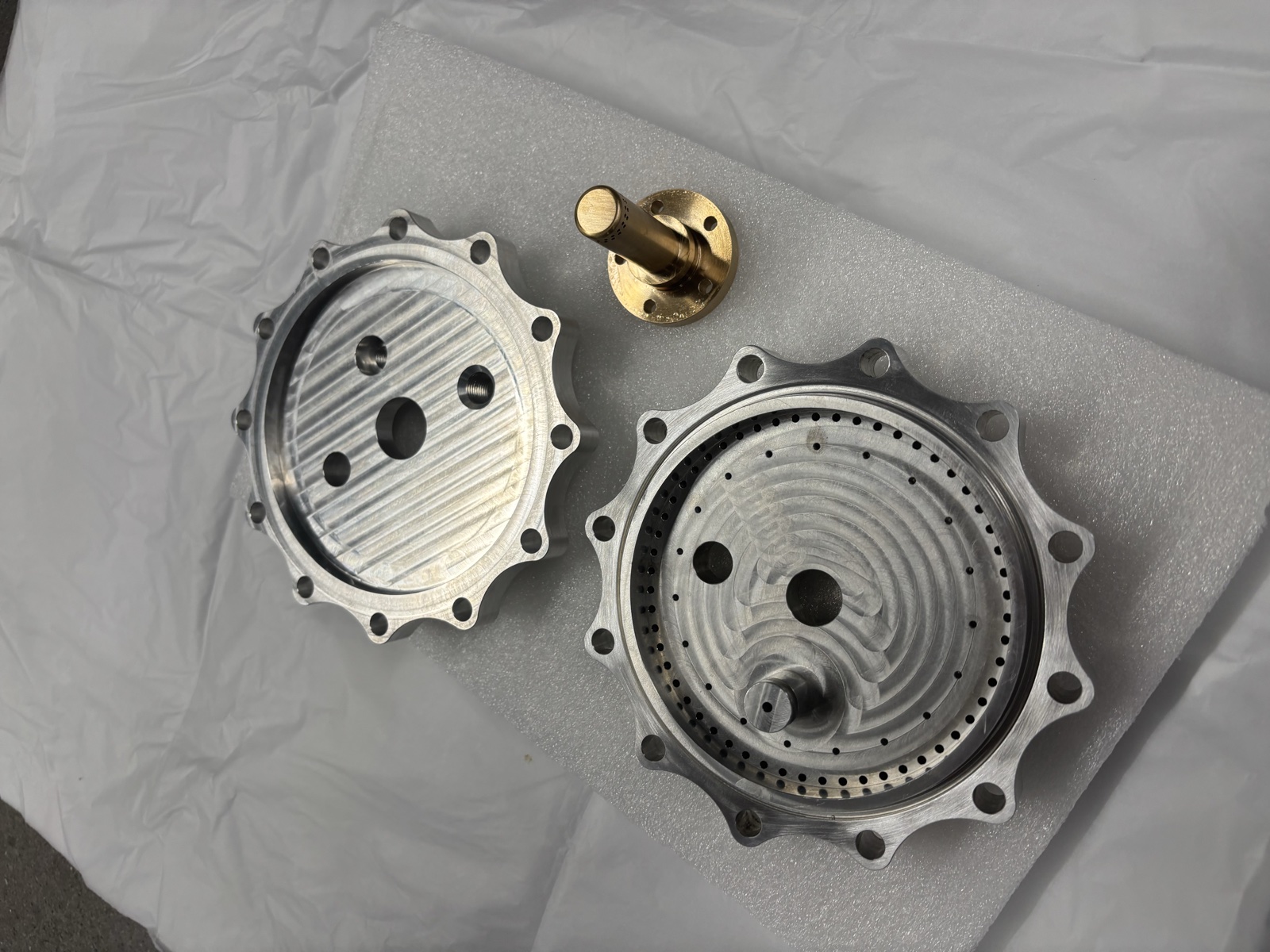 Machined injector face plates and pintle before assembly