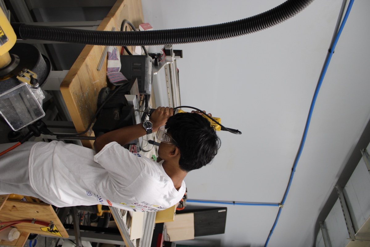 Team member machining hardware on a mill
