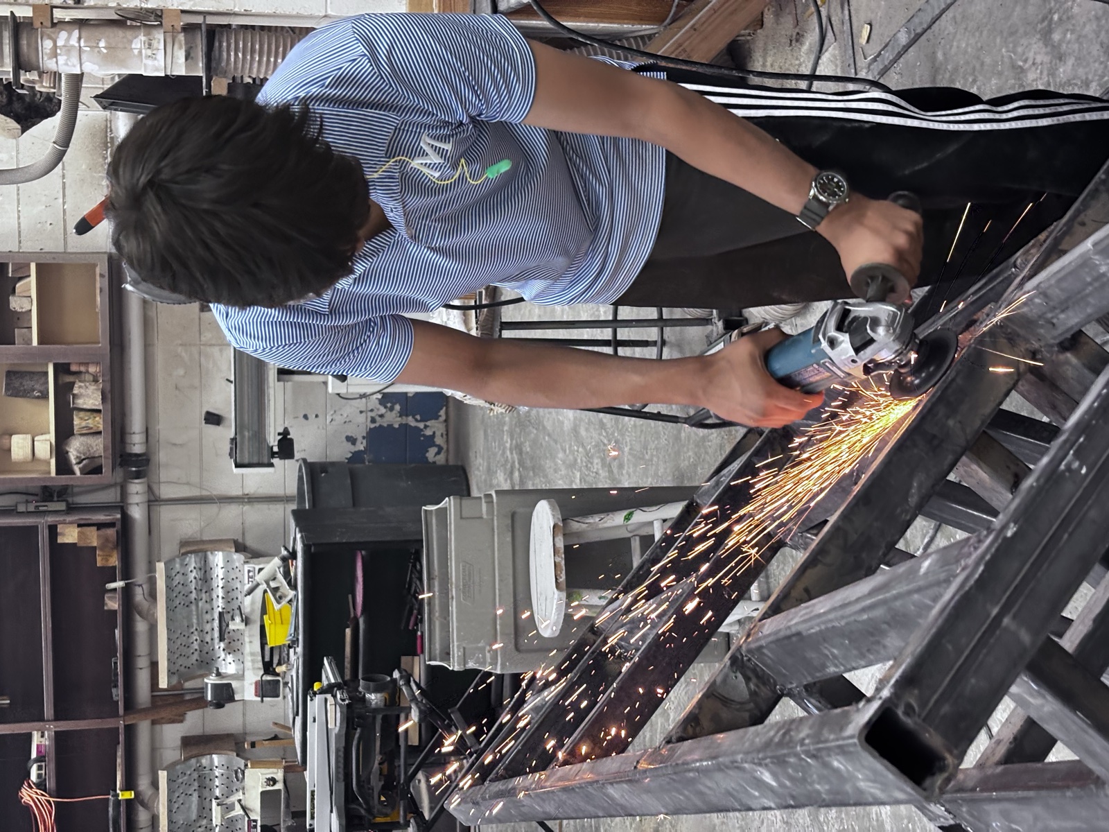 Team member grinding steel for the test stand frame